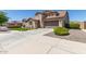 Attractive home with lush landscaping, enhanced by an extended driveway at 21918 E Maya Rd, Queen Creek, AZ 85142