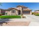 Charming single-Gathering home with a well-manicured lawn and a two-car garage at 21918 E Maya Rd, Queen Creek, AZ 85142