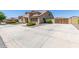 Attractive curb appeal with a spacious driveway and mature landscaping at 21918 E Maya Rd, Queen Creek, AZ 85142