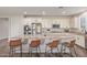 Open kitchen with a large island with seating, stainless steel appliances, and white cabinetry at 21918 E Maya Rd, Queen Creek, AZ 85142