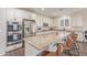 Modern kitchen featuring a large island with seating, stainless steel appliances, and granite countertops at 21918 E Maya Rd, Queen Creek, AZ 85142