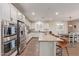 Bright kitchen with a large island, stainless steel appliances, and an adjacent dining area at 21918 E Maya Rd, Queen Creek, AZ 85142