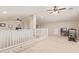 Open loft area with a staircase, carpet and multiple ceiling fans at 21918 E Maya Rd, Queen Creek, AZ 85142