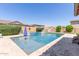 Private pool featuring tiled accents, a waterfall feature, and stone pavers for a luxurious experience at 21918 E Maya Rd, Queen Creek, AZ 85142
