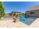 Inviting pool area with a separate spa, lush landscaping, and a patio, perfect for relaxation at 21918 E Maya Rd, Queen Creek, AZ 85142