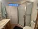 Bathroom featuring a sink, vanity, toilet, and a shower with a sliding glass door, creating a functional space at 2192 W Taos Ave, Apache Junction, AZ 85119