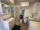Bathroom featuring a sink, vanity, walk-in shower, storage cabinet, and washing machine at 2192 W Taos Ave, Apache Junction, AZ 85119