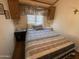 Cozy bedroom featuring a comfortable bed, bedside tables, and wall decor, creating a relaxing retreat at 2192 W Taos Ave, Apache Junction, AZ 85119