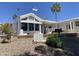 This white house has landscaping and palm trees at 2192 W Taos Ave, Apache Junction, AZ 85119