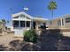 This white house has landscaping and palm trees at 2192 W Taos Ave, Apache Junction, AZ 85119