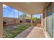 Covered patio overlooking the backyard with block wall and immature landscaping at 2206 S 114Th Ln, Avondale, AZ 85323