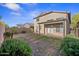 Fenced backyard features a covered patio and immature landscaping at 2206 S 114Th Ln, Avondale, AZ 85323