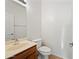 Well-lit bathroom featuring a single sink vanity, mirror, and toilet at 2206 S 114Th Ln, Avondale, AZ 85323