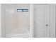 Clean, well-lit bathtub with white tile, small window and built-in shower head at 2206 S 114Th Ln, Avondale, AZ 85323