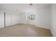Bedroom features tile flooring, window with blinds, and sliding-door closet at 2206 S 114Th Ln, Avondale, AZ 85323
