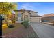Attractive two-story home featuring manicured landscaping, neutral tones, and an attached two-car garage at 2206 S 114Th Ln, Avondale, AZ 85323