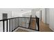 Bright hallway featuring neutral walls, tiled floors, and black iron railing overlooking lower level at 2206 S 114Th Ln, Avondale, AZ 85323