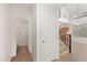 Hallway leading to a bathroom, with stairs and an overhead view of the kitchen at 2206 S 114Th Ln, Avondale, AZ 85323