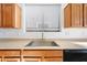 Close-up of stainless steel kitchen sink and wood cabinets at 2206 S 114Th Ln, Avondale, AZ 85323