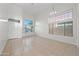 Inviting open-concept living room featuring tile floors and abundant natural light from large windows at 2206 S 114Th Ln, Avondale, AZ 85323