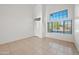 Bright living room with tile floors and a large window showcasing a serene view of the outdoors at 2206 S 114Th Ln, Avondale, AZ 85323