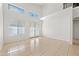 Bright living room with tile flooring, high ceilings, and French doors at 2206 S 114Th Ln, Avondale, AZ 85323