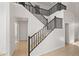 Dramatic staircase with dark wood railings and tile flooring, connecting multiple levels at 2206 S 114Th Ln, Avondale, AZ 85323