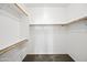 Walk-in closet with multiple shelves, rods, and neutral carpeting at 2206 S 114Th Ln, Avondale, AZ 85323