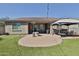Large backyard with artificial grass, a cozy patio, and a dining area at 2221 W Madisen Marie Ave, Queen Creek, AZ 85144