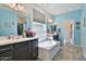 Bright bathroom featuring double sinks, a soaking tub, and neutral color palette at 2221 W Madisen Marie Ave, Queen Creek, AZ 85144