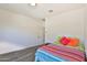 This bright bedroom features wood floors, a colorful bed, and a well lit space to create a serene enviornment at 2221 W Madisen Marie Ave, Queen Creek, AZ 85144