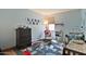 bedroom features a carpet, crib and a rocking chair at 2221 W Madisen Marie Ave, Queen Creek, AZ 85144