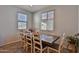 Cozy dining room featuring a wooden table, with seating for eight, with natural light from two windows at 2221 W Madisen Marie Ave, Queen Creek, AZ 85144