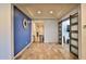 Stylish entryway with wood-look tile flooring, a decorative clock, and a sliding barn door at 2221 W Madisen Marie Ave, Queen Creek, AZ 85144