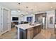 Open concept kitchen with a large island overlooking the living room, perfect for entertaining guests at 2221 W Madisen Marie Ave, Queen Creek, AZ 85144