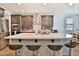 Modern kitchen island with counter seating, stylish backsplash, and stainless steel appliances at 2221 W Madisen Marie Ave, Queen Creek, AZ 85144