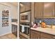 Kitchen with stainless steel appliances and dark cabinets at 2221 W Madisen Marie Ave, Queen Creek, AZ 85144