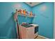 Laundry room with washer, dryer, and wall storage on shelves at 2221 W Madisen Marie Ave, Queen Creek, AZ 85144
