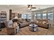 Open-concept living room with a ceiling fan, recessed lights, and large windows for natural light at 2221 W Madisen Marie Ave, Queen Creek, AZ 85144