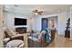 A cozy living room featuring wood floors, with a flat-screen TV and comfortable couches, creates a welcoming space at 2221 W Madisen Marie Ave, Queen Creek, AZ 85144