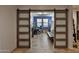 Bright home office with a sliding barn door, a desk, and comfortable seating for productivity at 2221 W Madisen Marie Ave, Queen Creek, AZ 85144