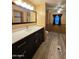 Bathroom featuring a modern vanity, ample counter space, and wood-look flooring at 2233 E Behrend Dr # 84, Phoenix, AZ 85024