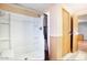 Bright bathroom featuring a white shower with a stylish shower curtain and an adjacent door at 2233 E Behrend Dr # 84, Phoenix, AZ 85024