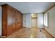 Bedroom featuring wood floors and large built-in wood wardrobe with decorative sunflower wallpaper border at 2233 E Behrend Dr # 84, Phoenix, AZ 85024