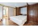 Bedroom featuring a Murphy bed, built in cabinets, and wood-look flooring with hallway access at 2233 E Behrend Dr # 84, Phoenix, AZ 85024