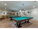 Spacious billiard room with two pool tables, pendant lighting, and a stylish tile floor at 2233 E Behrend Dr # 84, Phoenix, AZ 85024