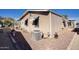 Exterior corner view of home with rock landscaping, awning-covered windows, and an AC unit at 2233 E Behrend Dr # 84, Phoenix, AZ 85024