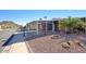 Exterior street view of a home with covered parking and mature landscaping in a desert setting at 2233 E Behrend Dr # 84, Phoenix, AZ 85024