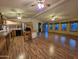 Open-concept living room featuring wood-look flooring, ceiling fans, and ample natural light at 2233 E Behrend Dr # 84, Phoenix, AZ 85024