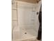White shower with built-in shelving, a shower head, and a decorative shower curtain at 2233 E Behrend Dr # 84, Phoenix, AZ 85024